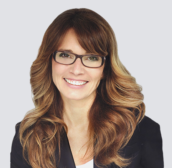 Smiling woman in glasses and a blazer