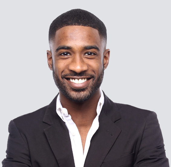 Man in a black jacket and white shirt smiling